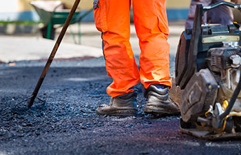 worker providing asphalt repair service