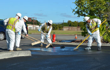 crew of pavers sealcoating asphalt